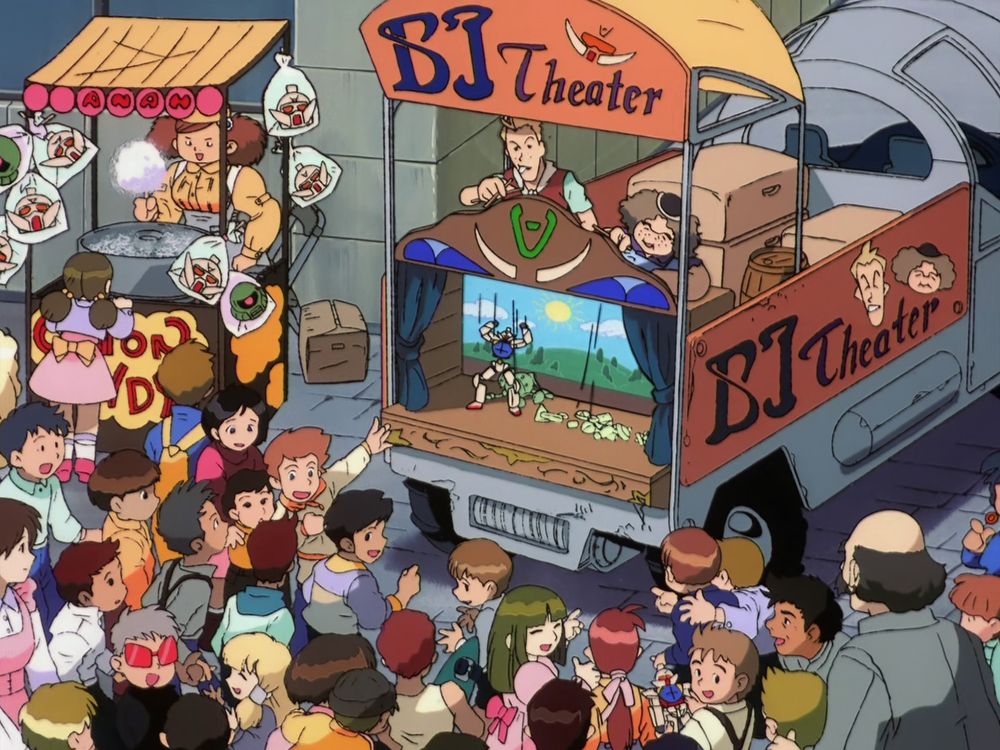 "BJ Theater" (yes, BJ Theater) putting on a marionette Gundam show. In the audience is a kid dressed like Harry Ord