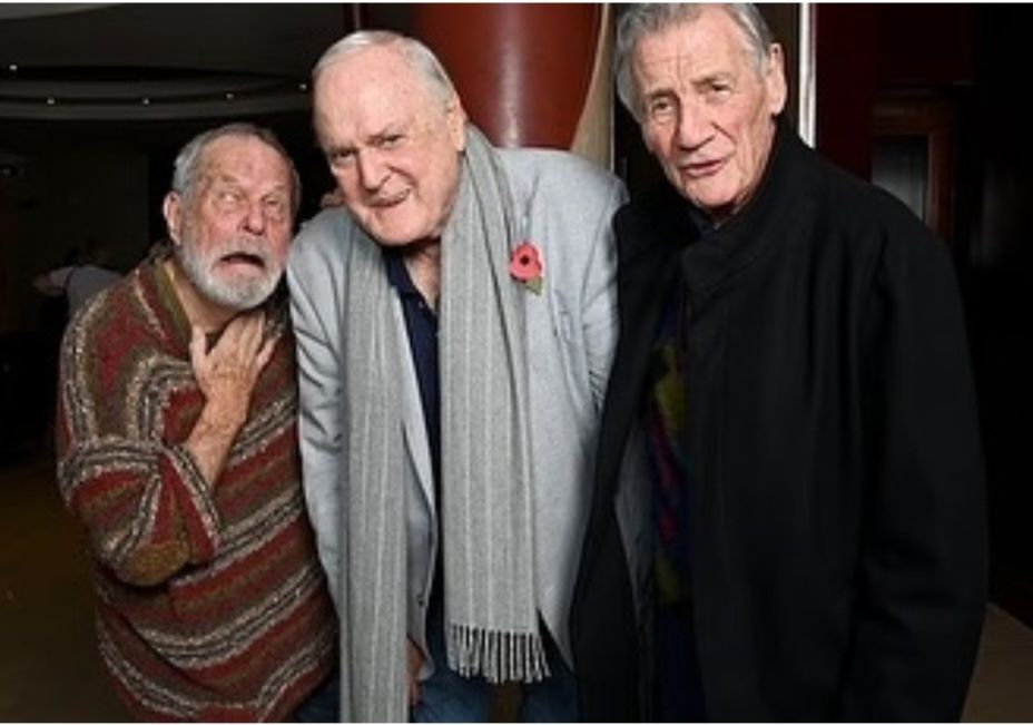 Terry Gilliam, John Cleese, and Michael Palin of Monty Python horsing around at the premiere of John Cleese Packs It In