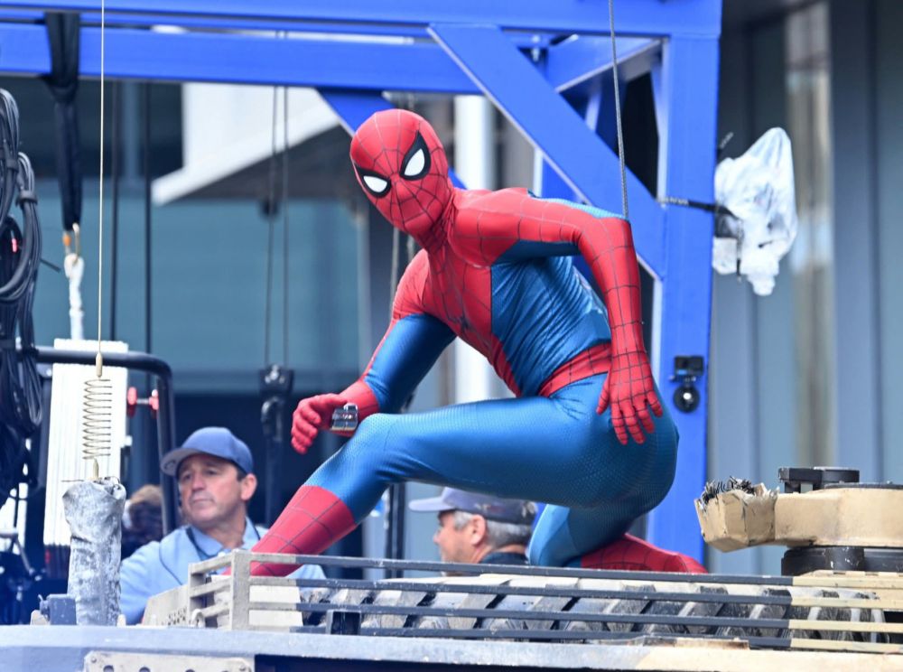 A production shot from Spider-Man: Brand New Day, showing Tom Holland in suitably Spidey-like pose, on the streets of... Glasgow, apparently??