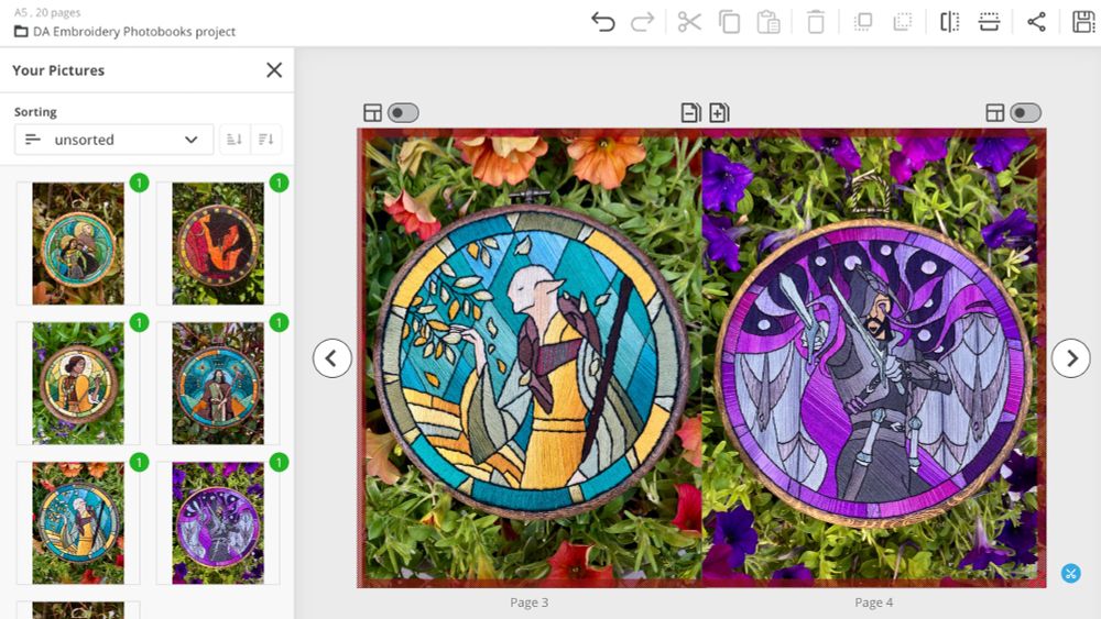 screenshot of a page layout from an online photobook editor, showing a digital mockup of a booklet with two photos of embroideries filling each page. There is a Solas stained-glass style embroidery with a background of greenery and orange petunias, and a Lucanis embroidery on greenery with purple petunias. 