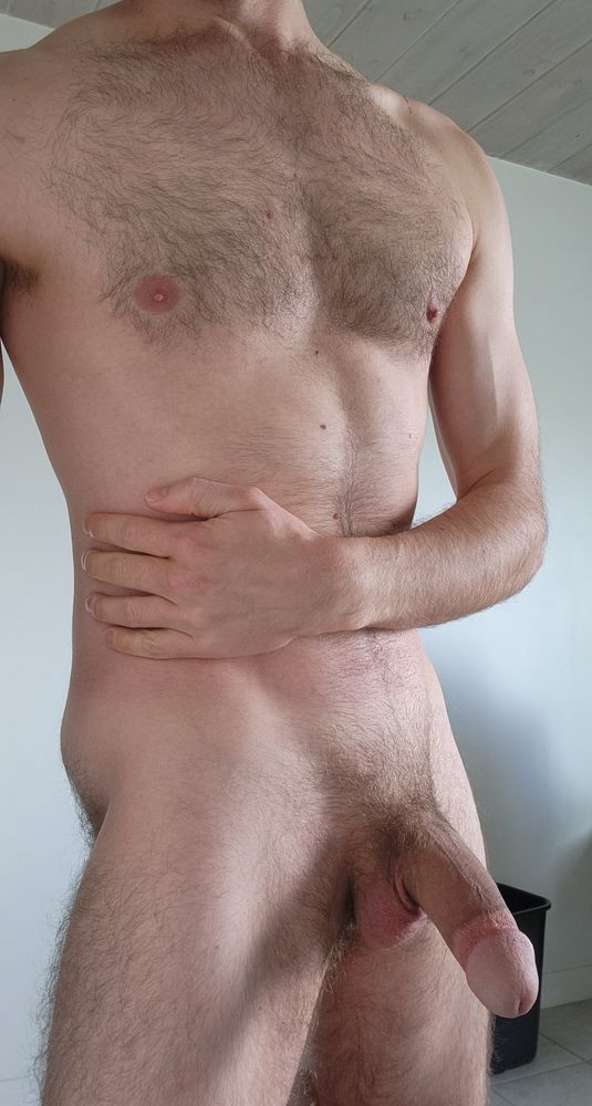 Myself completely nude showing off my flaccid cock and balls.