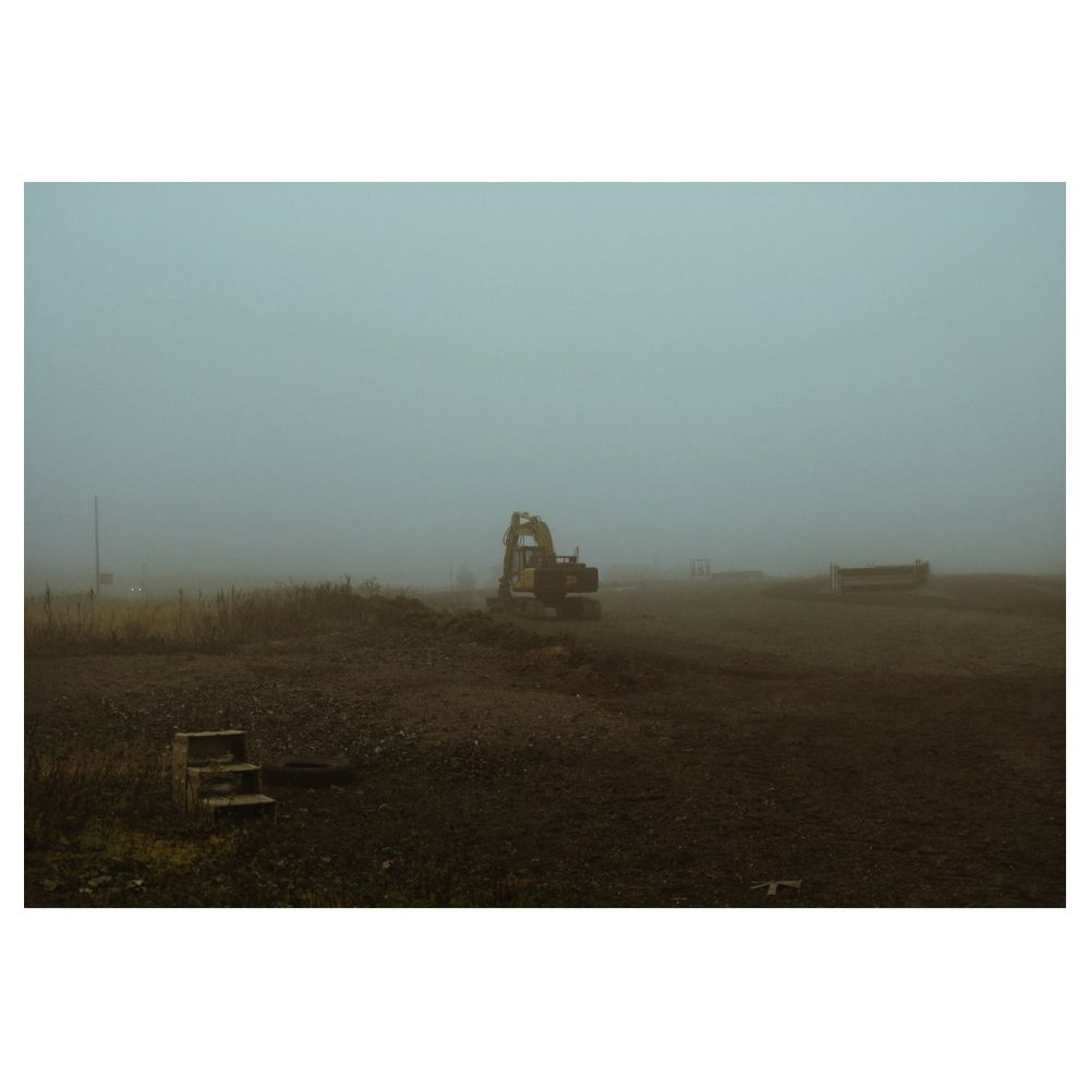 A digger upon a mist-shrouded hilltop.