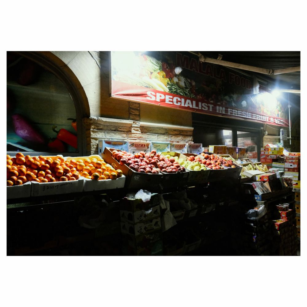 Starkly lit fruit and veg stall in Bradford, taken at night.