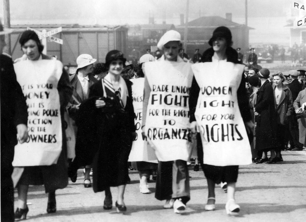 Four women with signs reading Fight for your Rights, Fight for the right to Organize.
