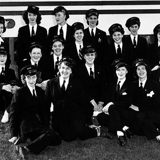 A group of women in uniforms pose for photograph.