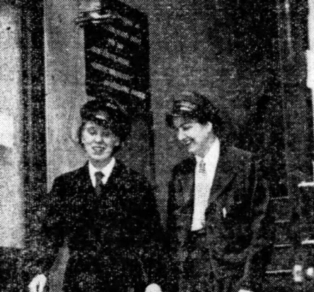 Two women in transit uniforms leaving a building