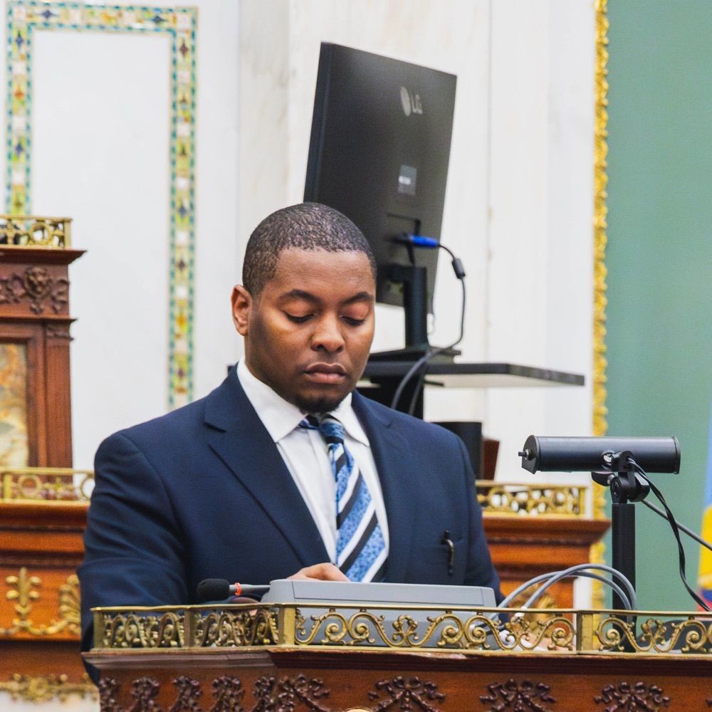 Jawad Pullin standing behind a podium in council chambers