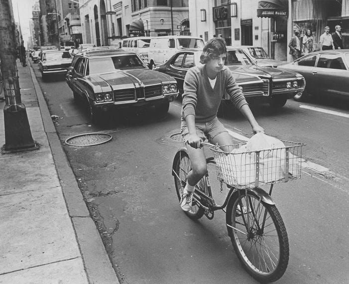 Image 8. "Making deliveries in the city by bicycle is fuel efficient, but can be hazardous...Messenger Thomas DeVuono navigates in traffic on Walnut st., west of 16th." (Owens. “Cyclists and traffic” October 7, 1978. George D. McDowell Philadelphia Evening Bulletin Collection.)