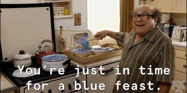 still from always sunny of frank cooking a pot of something blue and gooey at the stove, he says “you’re just in time for a blue feast”