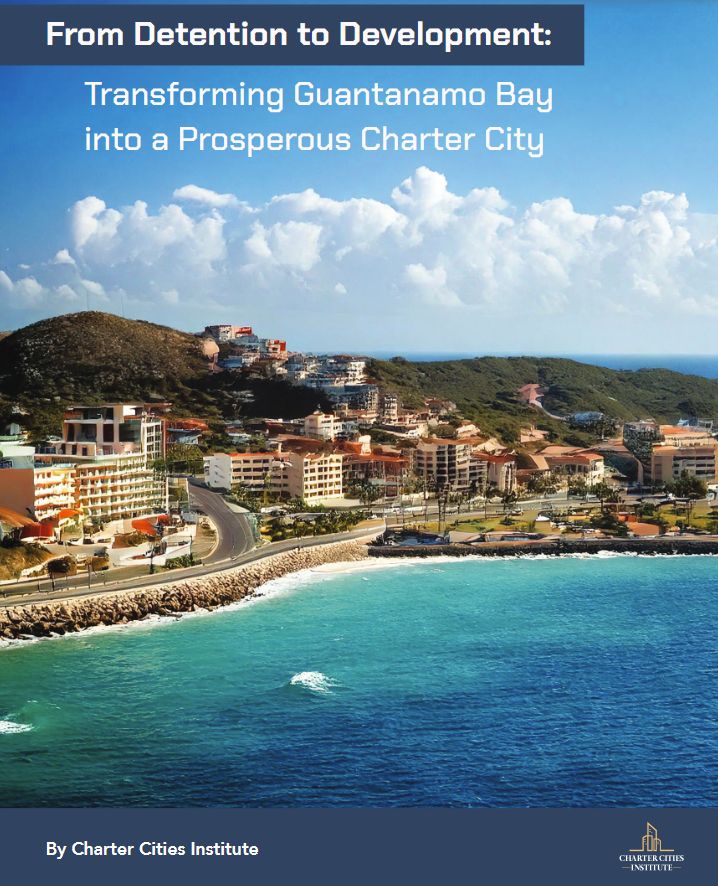 Graphic: From Detention to Development: Transforming Guantanamo Bay into a Prosperous Charter City . Illustration of a beachside resort with fairly high density condos and a road running along the shoreline. Looks moderately prosperous