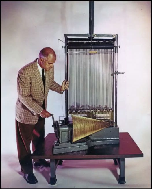 retro image of a Michelson mechanical Fourier analysis and synthesis machine. it's very complicated and large and mechanical.