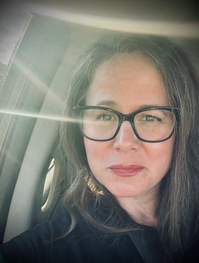 Pic of a girl with a sun beam across her forehead. 