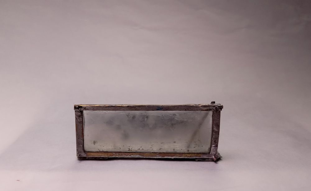 a metal & sanded glass sculpture that makes for a low horizontal front view