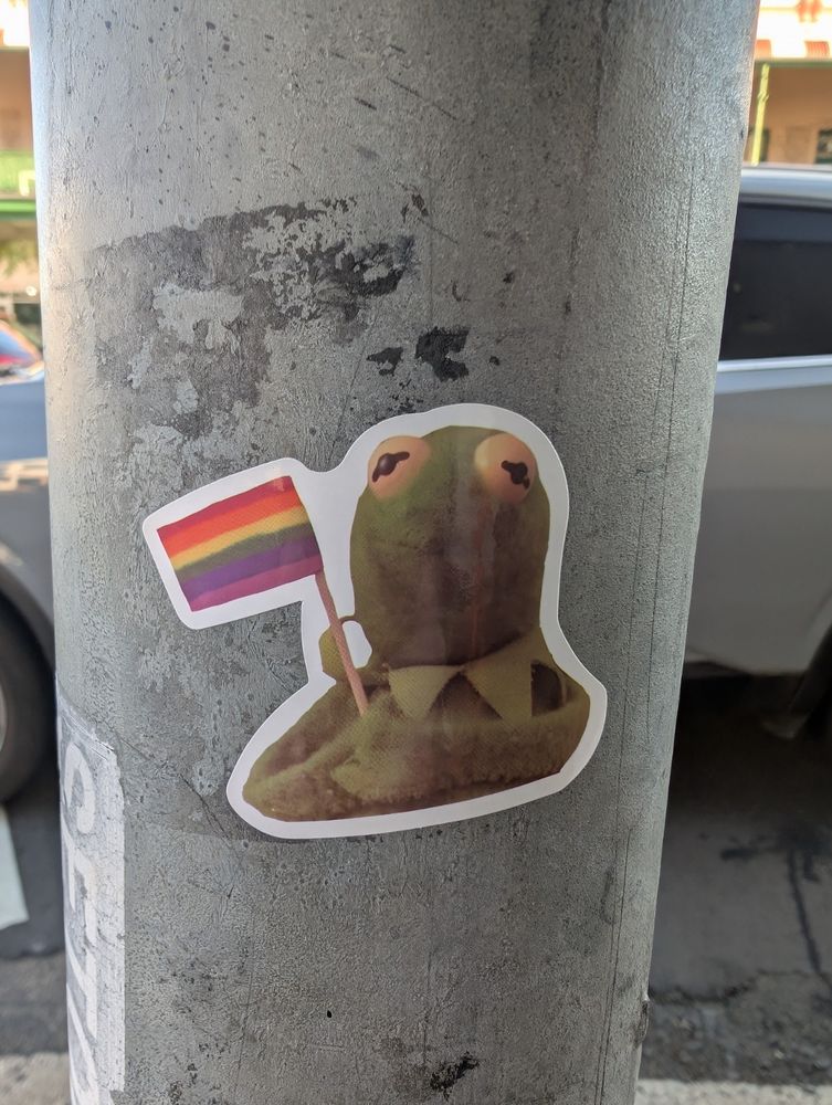 Kermit the frog sticker with an LGBT flag