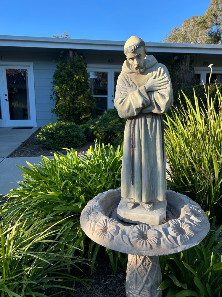 Statue of St. Francis, head bowed, arms crossed over his chest. A grateful humility, perhaps.