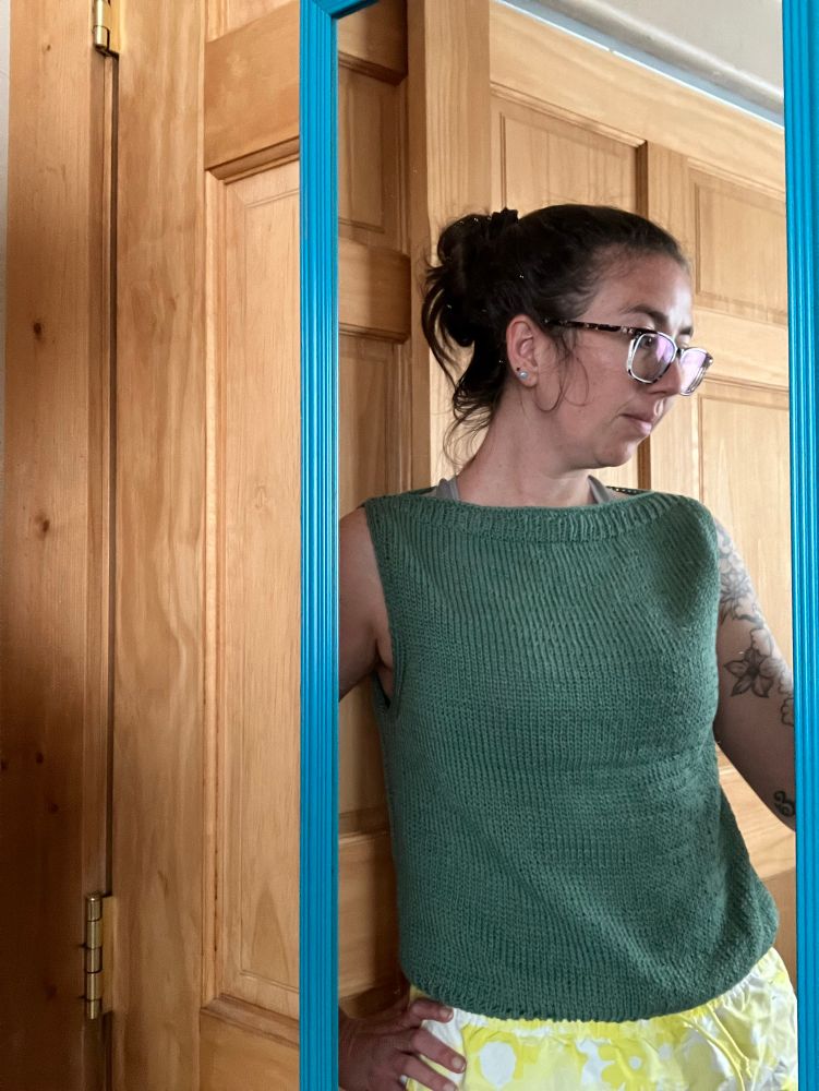 A freshly finished, pre-blocked Sabai top by Susanne Müller in a sage green bamboo cotton yarn