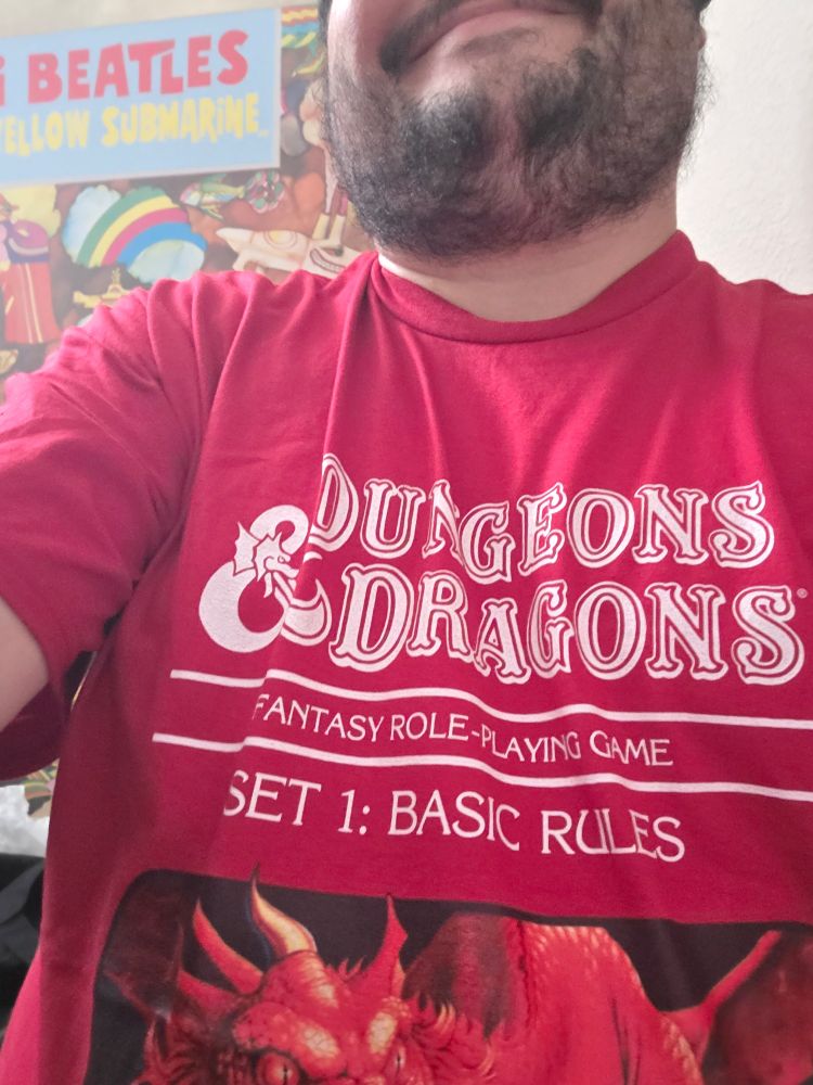 Me wearing a red shirt that has the D&D basic rules set art