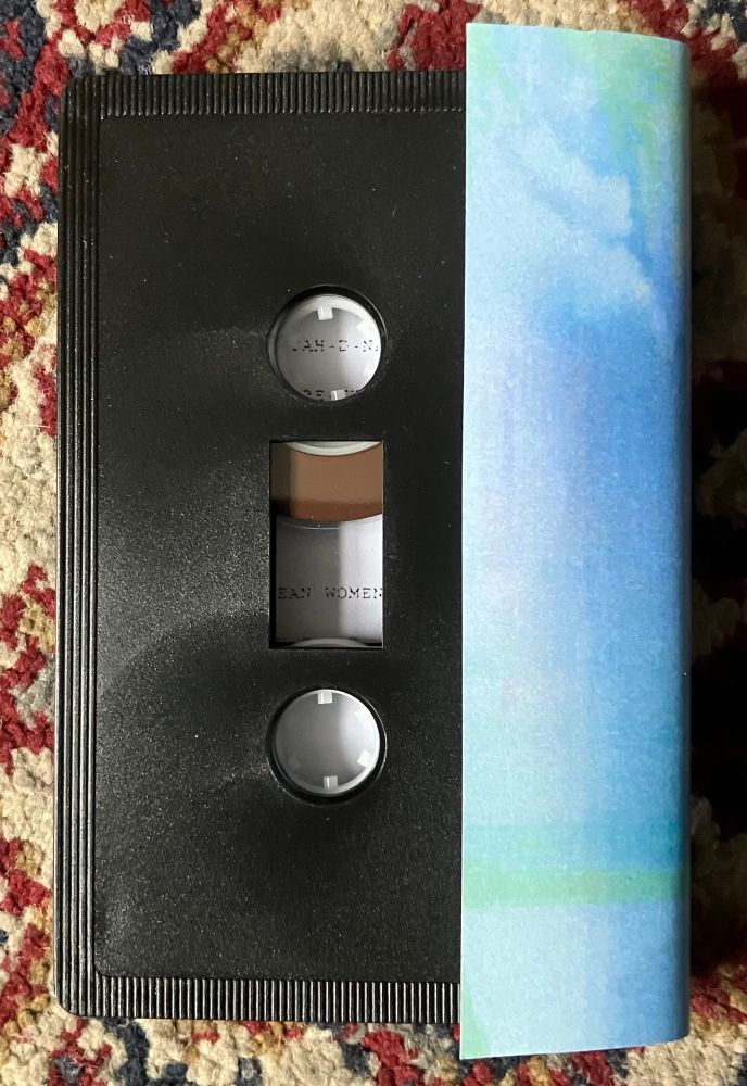 Black cassette, back of aqua blue/green j-card