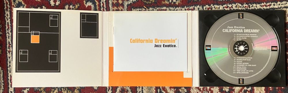 3 panel digipak, black geometric shapes on white, CD booklet with title in orange and black, the CD itself. 