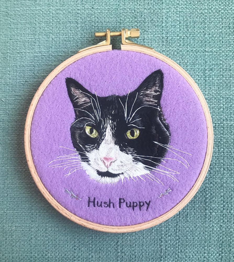 Embroidered tuxedo cat embroidery on lilac felt with the name Hush Puppy underneath. 