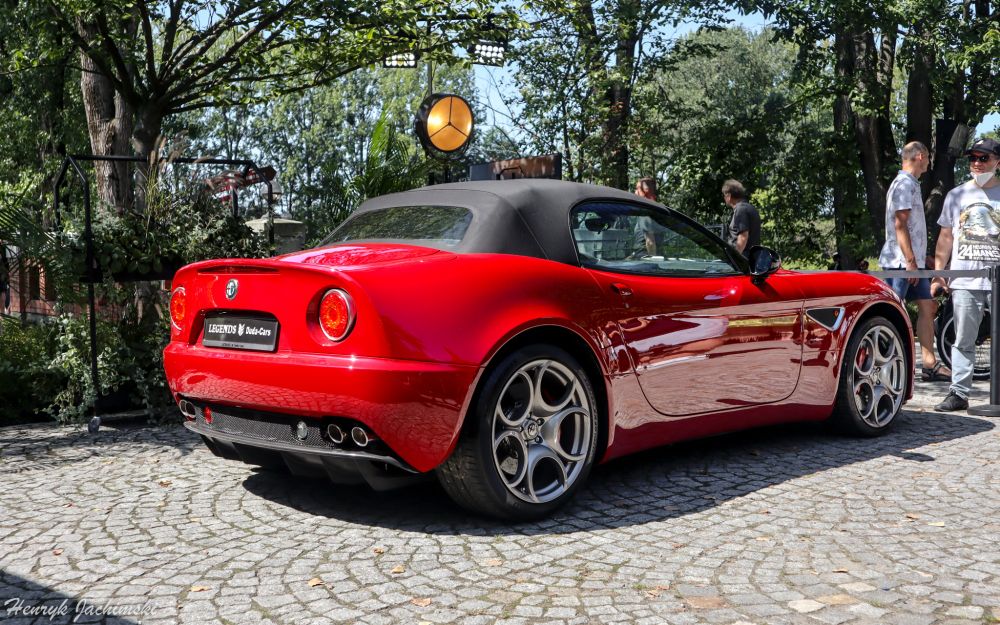 Alfa Romeo 8C Spider standing in the sunlight with some trees in the background