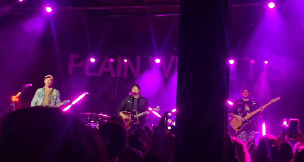 The Plain White T’s on stage with magenta lighting