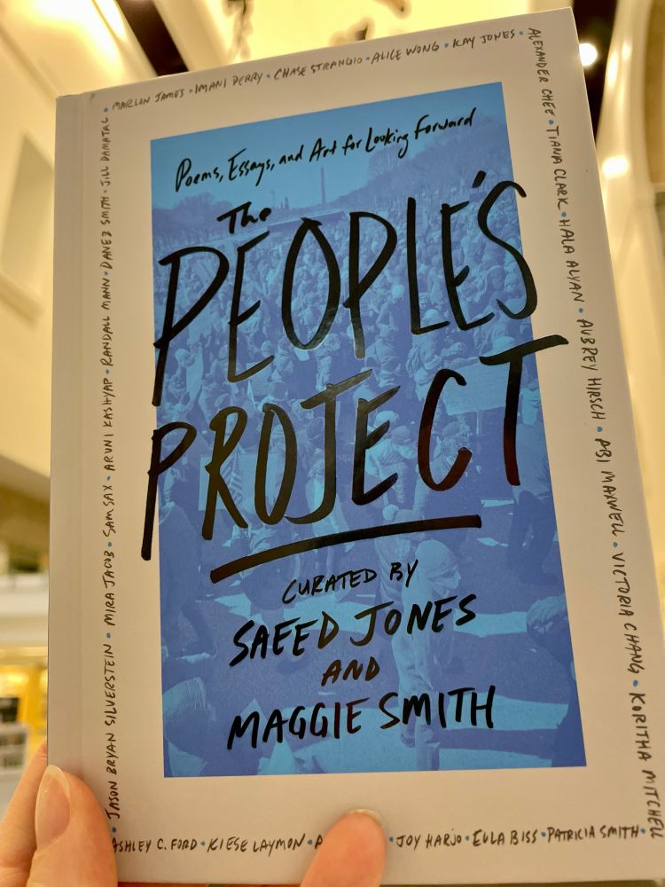 A blue and white book cover with “The People’s Project” in black ink.