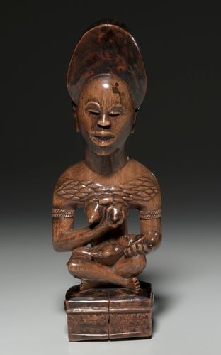 This mother-and-child figure was probably part of a cult concerned with the treatment of infertility. Both her jewelry and her seated pose indicate that the woman occupied a high rank in her community. Her miter-shaped hairstyle, chiseled teeth, and raised body scars--considered to be marks of beauty and perfection--signal that the woman incarnates the founding ancestor of a kinship group.
