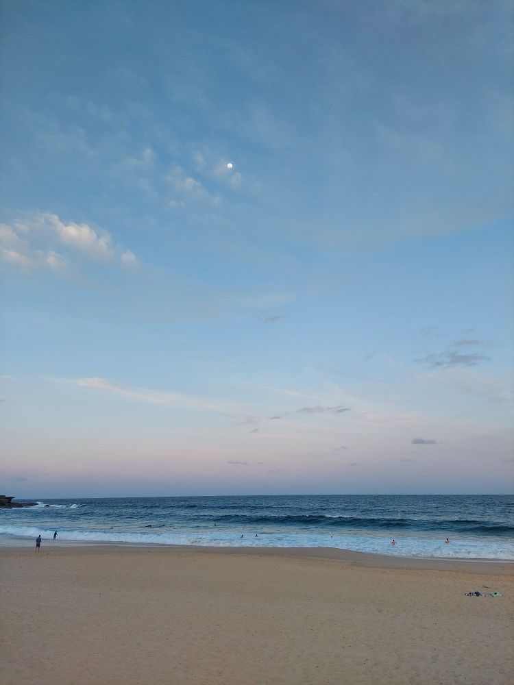 beach at dusk with a little pink to the clouds 