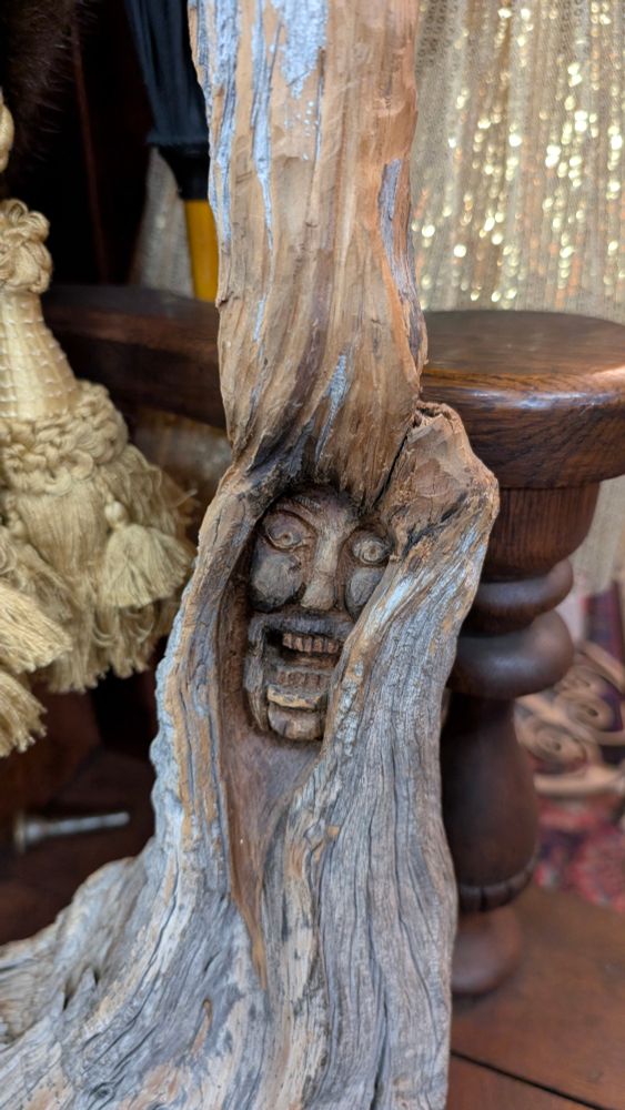 A close-up of the unhappy face that is carved into the driftwood. 