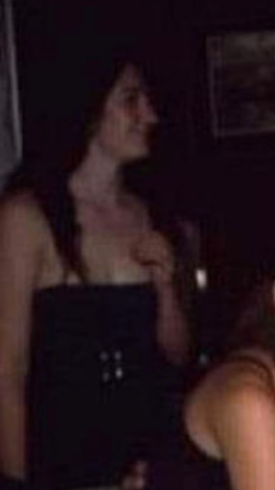 Young female in a low-cut strapless dress.