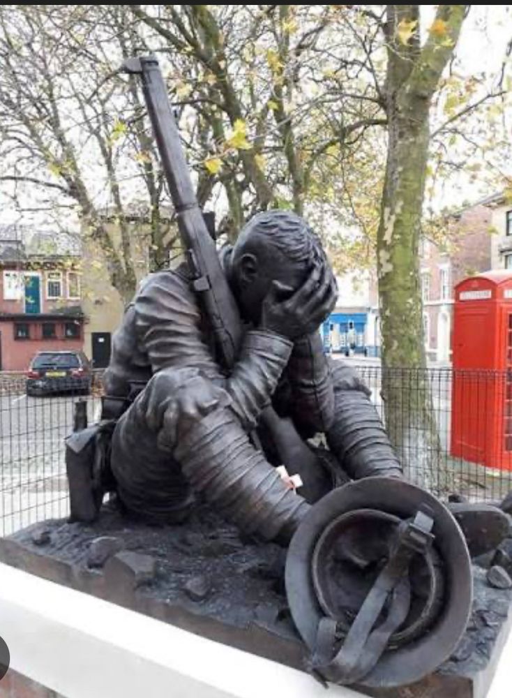 Statue of ww1 soldier with head in hands. 