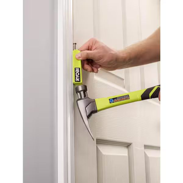 Photo of a person using a tool to remove a door hinge