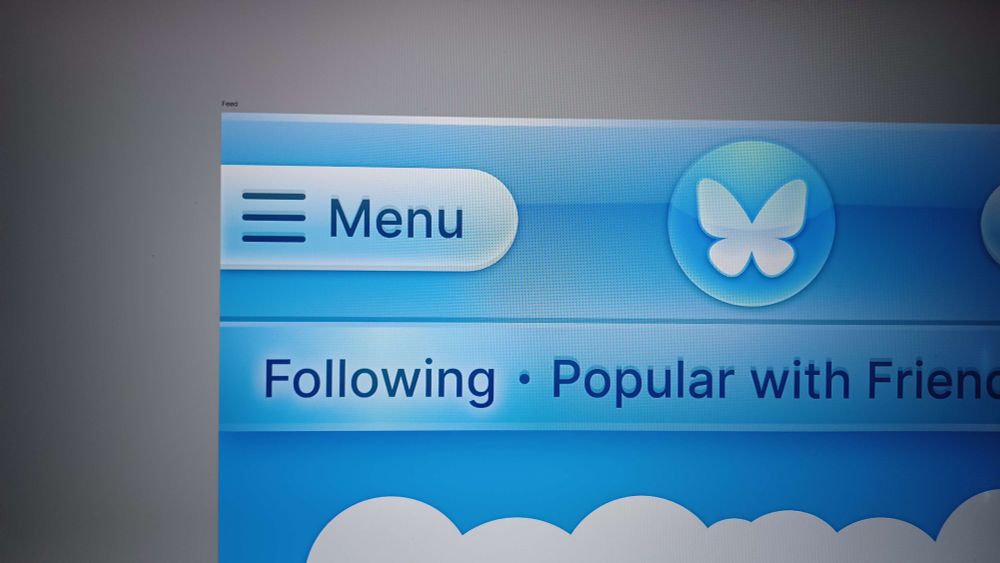 A glossy navbar with a menu tab visible, the bluesky logo in an orb, and the feeds. Below is what appears to be a cloud.