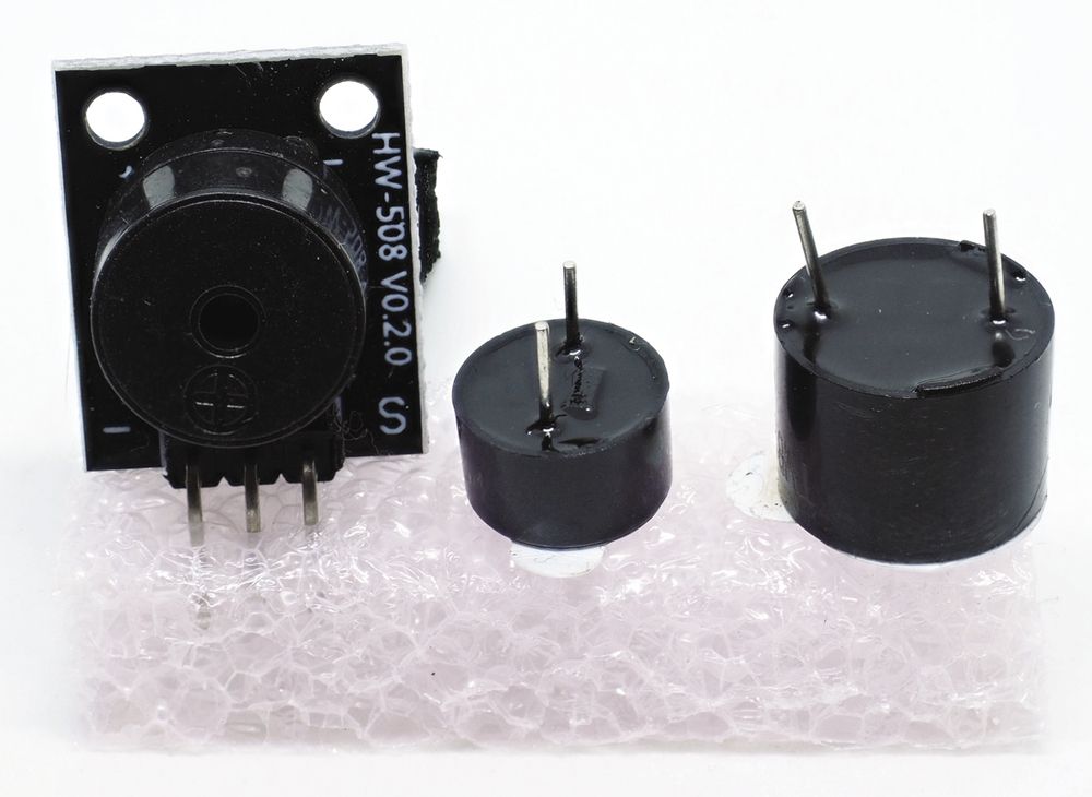 Photo of a passive buzzer (left) and two raw buzzers (center, right)
