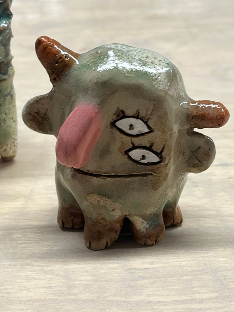 a weird little freak with 6 legs (though only 4 are visible). it has big eyes and nubby horns