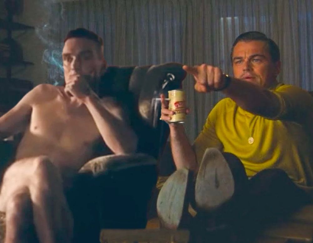 that shot of cillian murphy from oppenheimer where he’s naked in the chair but he’s photoshopped into the scene from once upon a time in hollywood where leo is pointing so they are sitting next to each other :)
