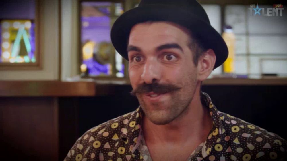 a man with a hat and a mustache is on a tv show called talent