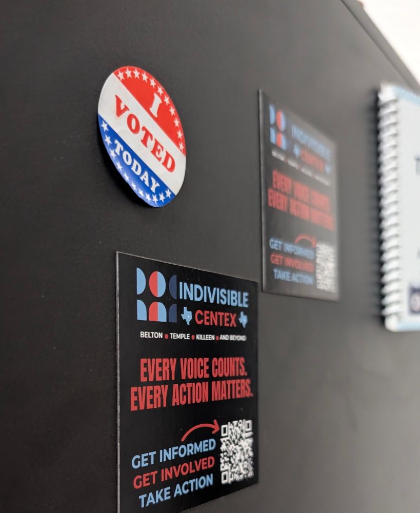 I voted today sticker, slightly peeled off, with indivisible centex magnets beside it on a metal black computer case.
