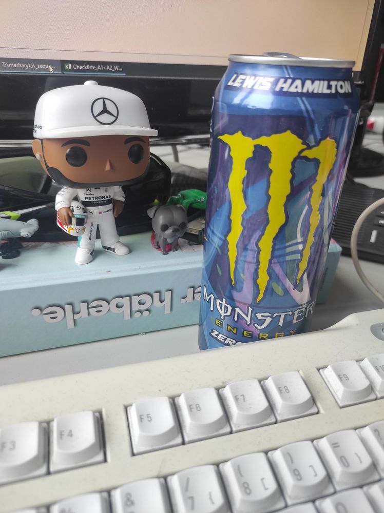 pic of my desk at work with Lewis Hamilton Funko Pop and Lewis Hamilton Monster energy drink