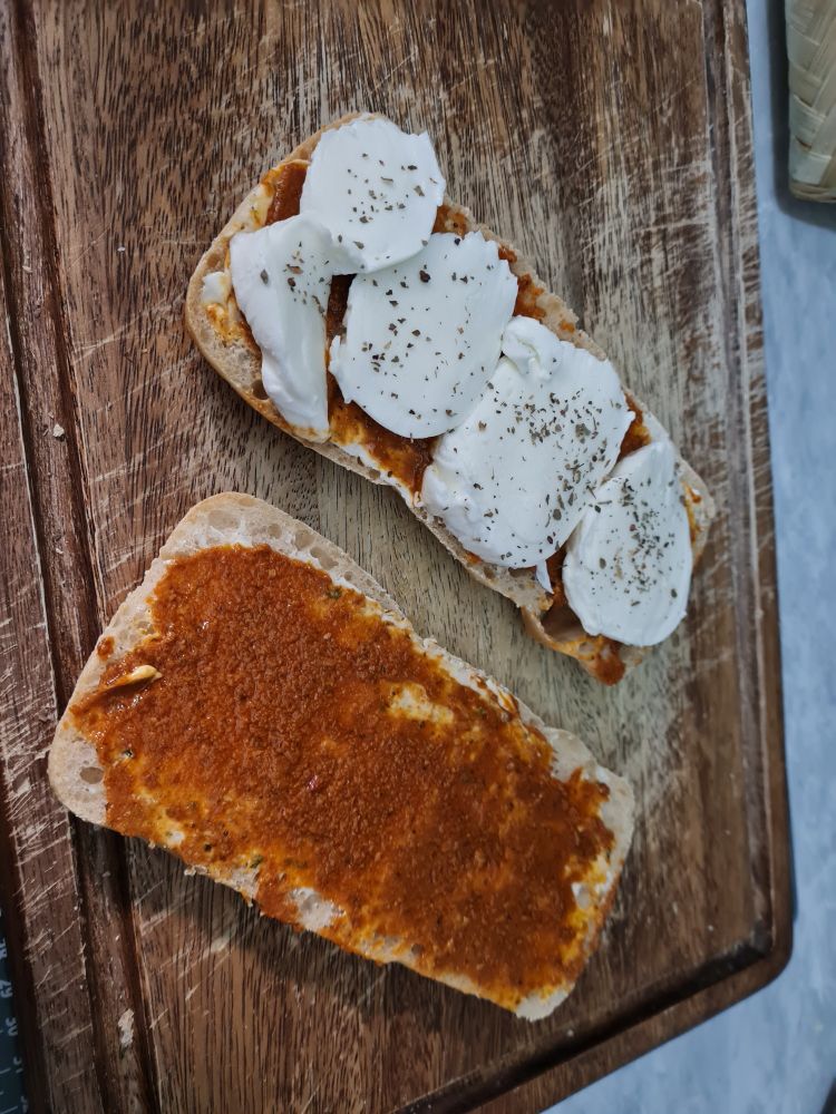 Mozzarella and sun-dried tomato pesto panini laid out ready to be cooked
