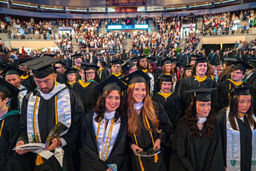 A crowd of graduating students, smiling at the camera