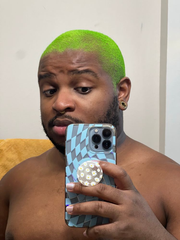 Shirtless selfie showing off my freshly-dyed green hair in a bathroom setting. 
