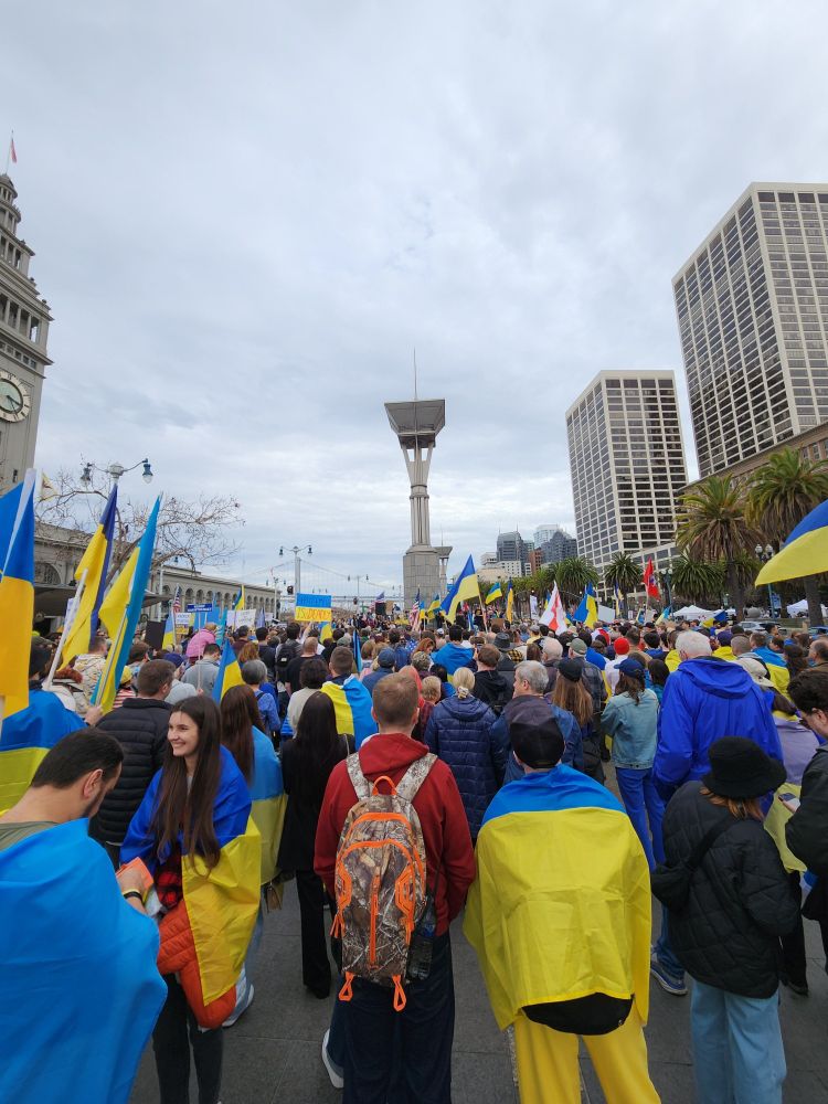 Demonstration by the San Francisco Ferry Building in support of Ukraine against Russia's invasion. Thousands waving flags in support.