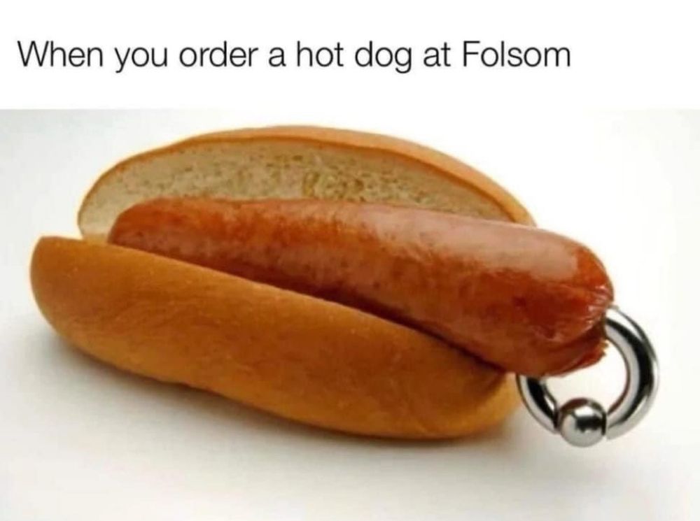 A picture of a hot dog with a piercing inside of a bun that says when you order a hot dog at folsom