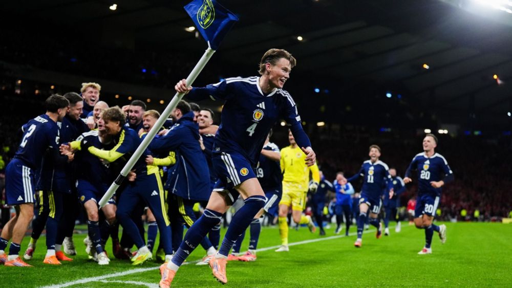 The Scotland team celebrate in the corner during their win over Denmark to qualify for the World Cup. Scott McTominay is running off with the corner flag in one hand, a look of delight on his and everyone's faces. Magical.