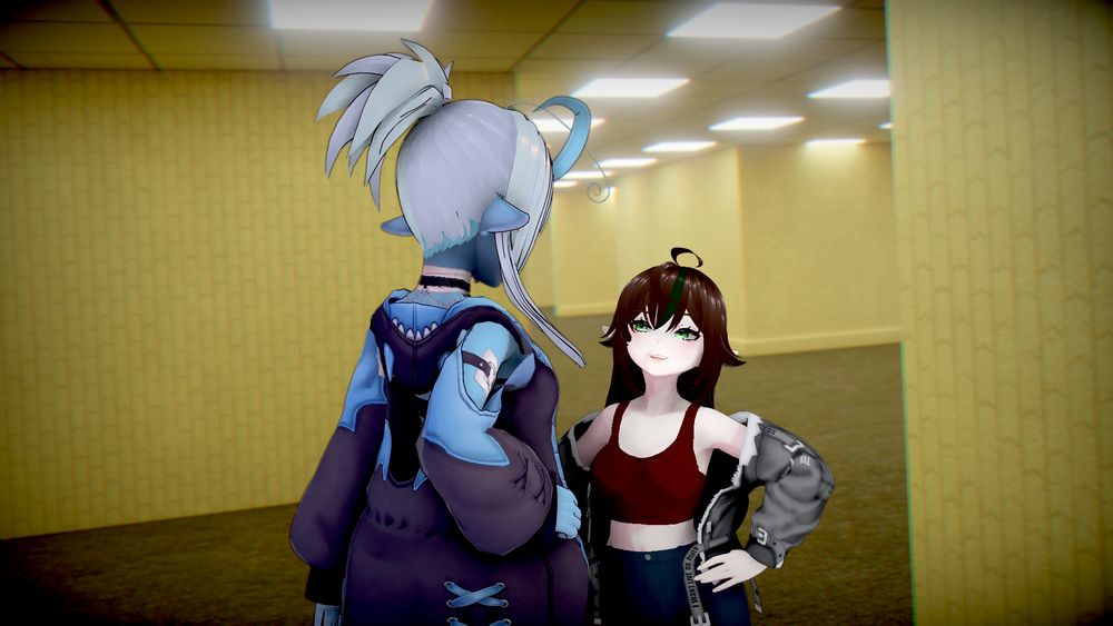 A shot of May looking up at Lily with a big, horny smile on her face! Lily looks down at her, hand on the hip. Background showing the backrooms. 