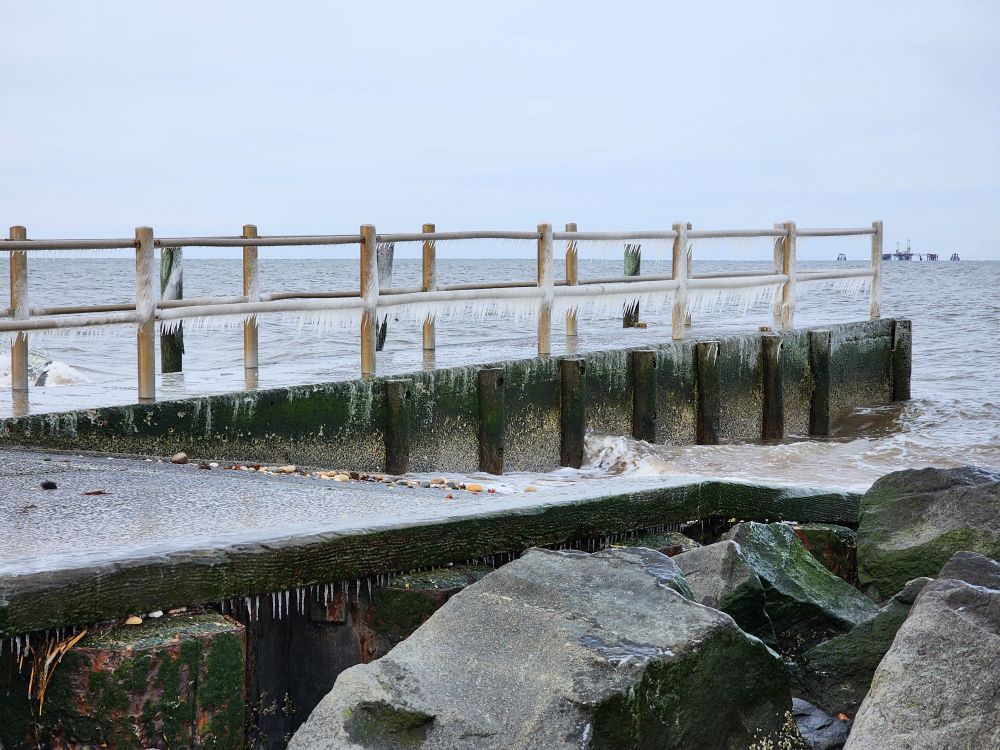 Pier with frozen sea spray.
