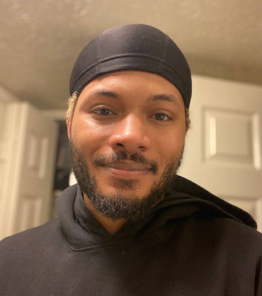 Ho’el selfie with a black wave cap and black hoodie on