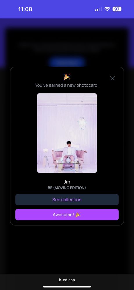 Screenshot of a moving digital photocard on the b-cd website. Shows BTS’ Jin sitting on a purple couch with his arms on the back of the couch.